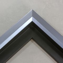 Unique geometric 1 " floater. The face of this molding features an off center peak which gives it a unique contrast in the right lighting.  This frame comes in Metallic Blue Pewter with a dull satin finish.
